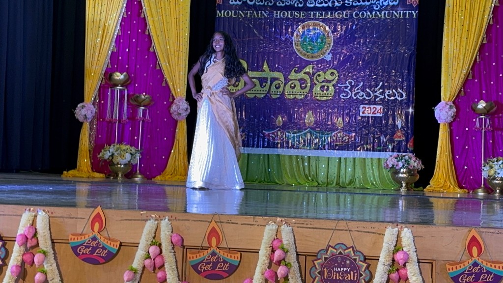 Tanvika Karupakula on stage at a Diwali celebration