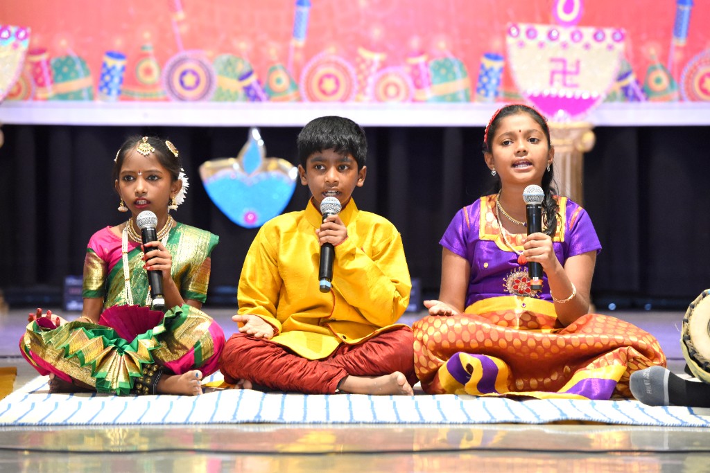 Tanvika Karupakula on stage with fellow performers
